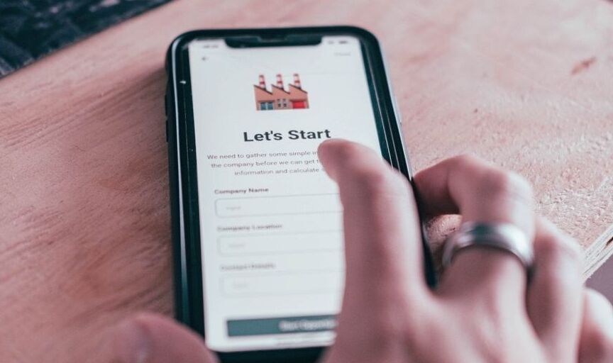 A customer uses a smart phone to begin the process of interacting with a business; the screen shows the message "Let's Start".