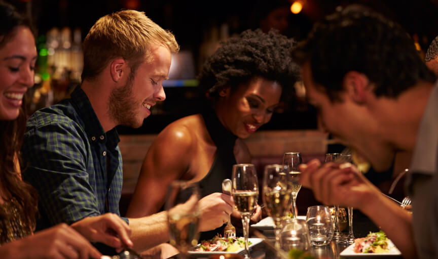 A group of diners in a restaurant enjoying a meal together.