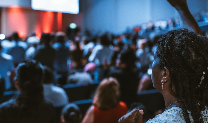 Seminar participant raises her arm to ask a question.
