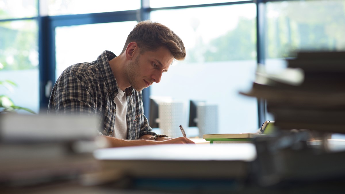 Man conducting secondary research from a range of sources