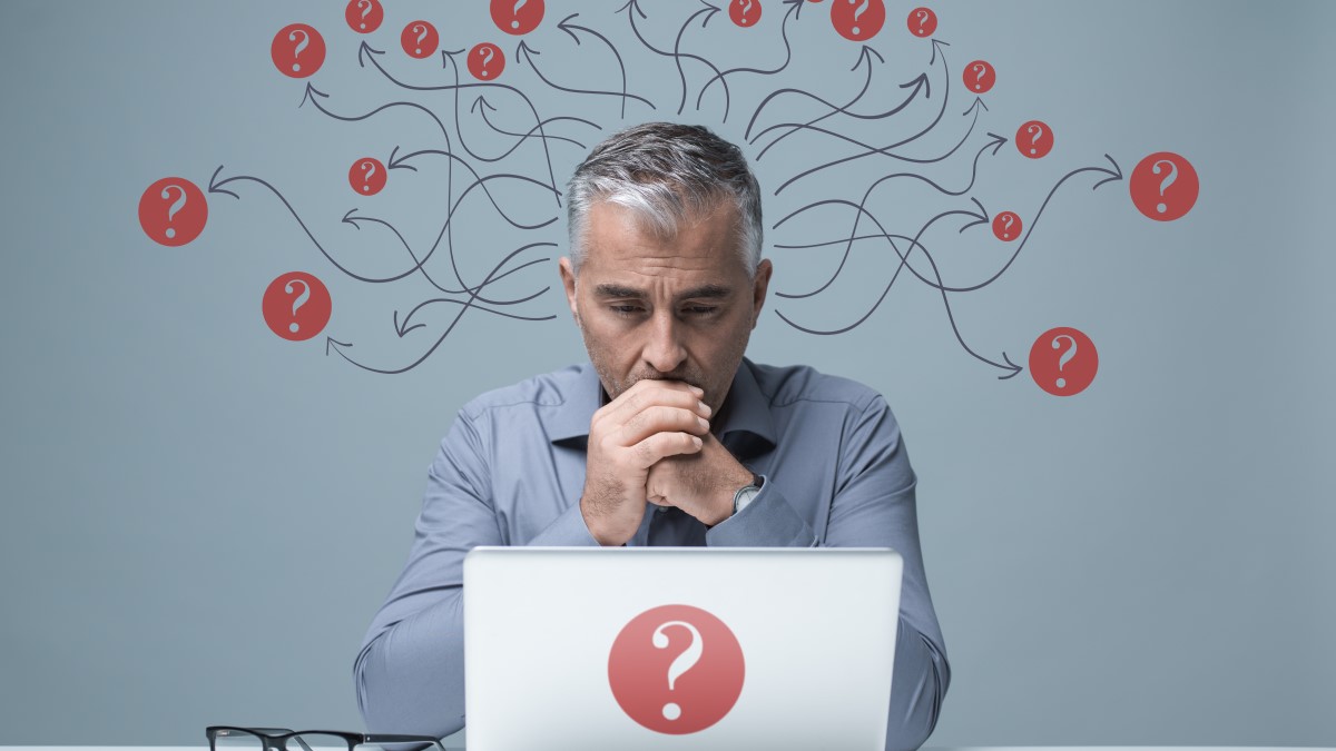 Pensive man wondering how best to answer a survey question