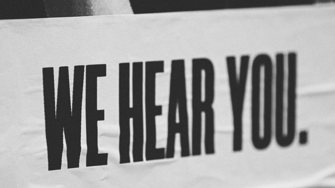 Sign reading "We hear you", to illustrate the importance of customer feedback