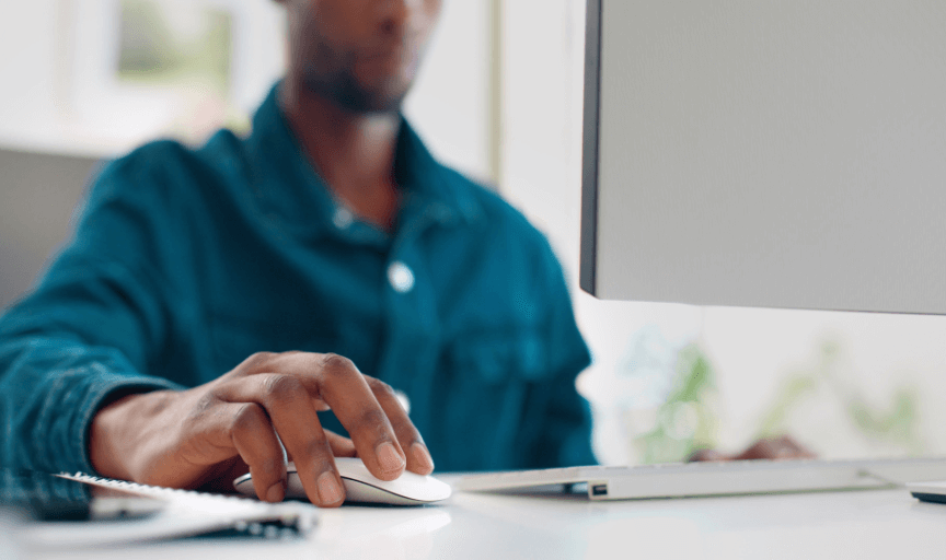 Researcher uses a mouse and desktop PC to make a good questionnaire