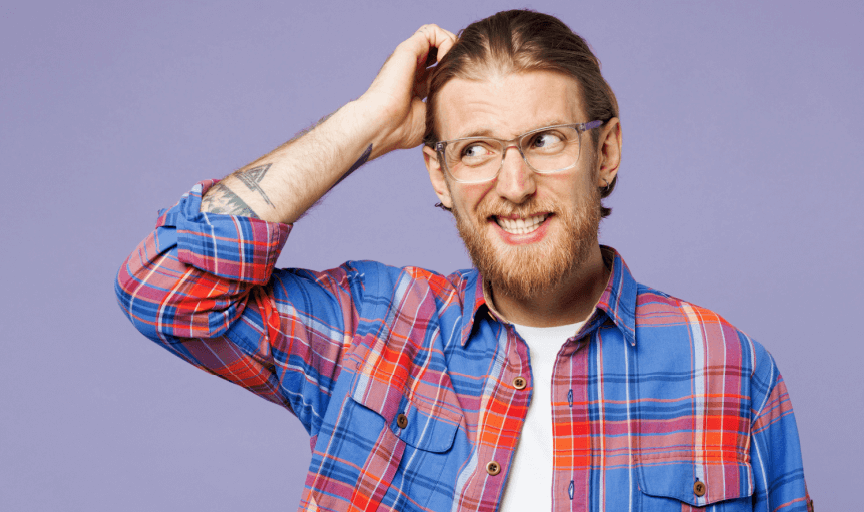 Male researcher looking puzzled and scratching his head, to illustrate the concept of how to get customer feedback
