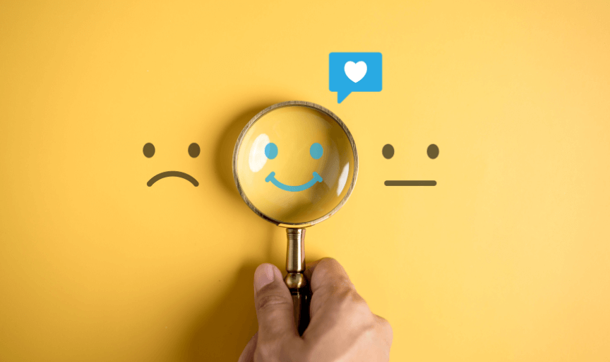 A magnifying glass hovers over a smiley face icon, to illustrate the positive outcomes from measuring customer service metrics